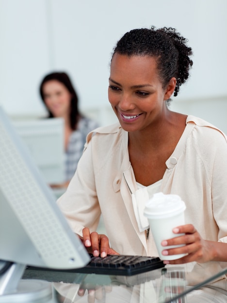 Delighted businesswoman drinking a coffee 