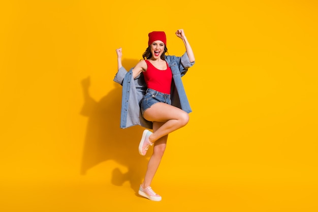 delighted cheerful girl celebrate win raise fists