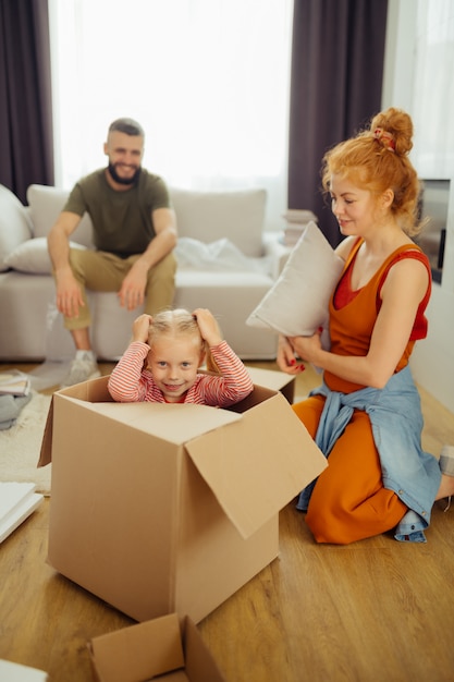 Delighted nice girl trying to hide in the box