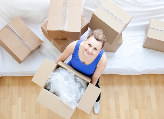 Delighted woman holding a box 