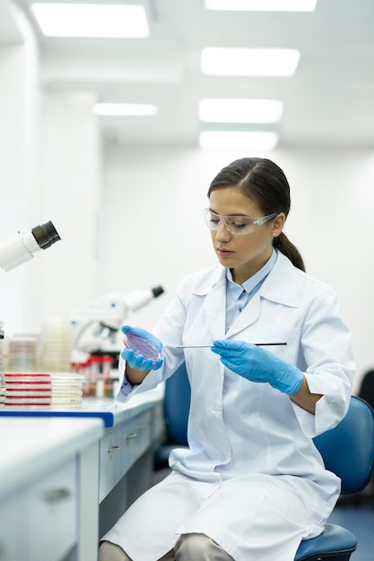 Delighted woman looking downwards while doing analysis