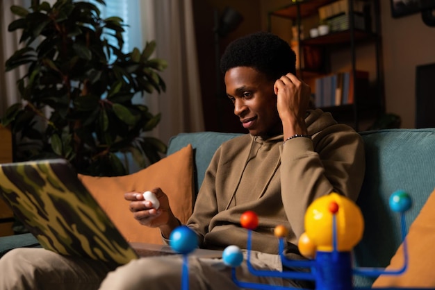 Delighted young successful african american dark skinned black man finishing up a video call or
