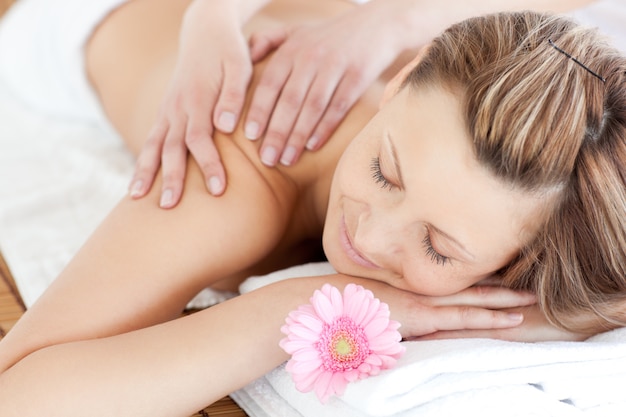 Delighted young woman receiving a back massage