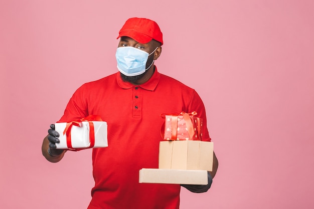 Delivery african american man employee in red cap blank t-shirt uniform face mask gloves hold empty cardboard box