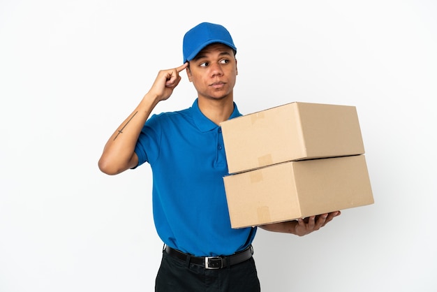 Delivery African American man isolated on white background having doubts and thinking