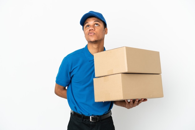 Delivery African American man isolated on white background and looking up