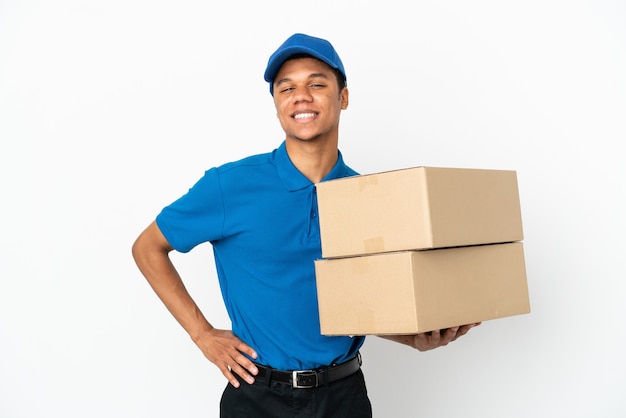 Delivery African American man isolated on white background posing with arms at hip and smiling