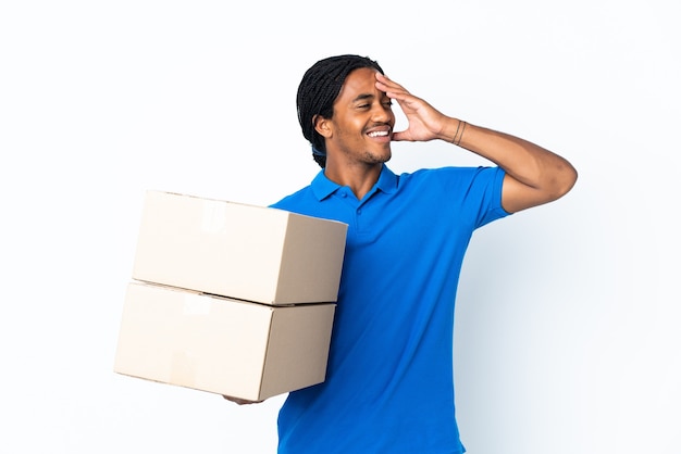 Delivery African American man with braids isolated on white wall smiling a lot