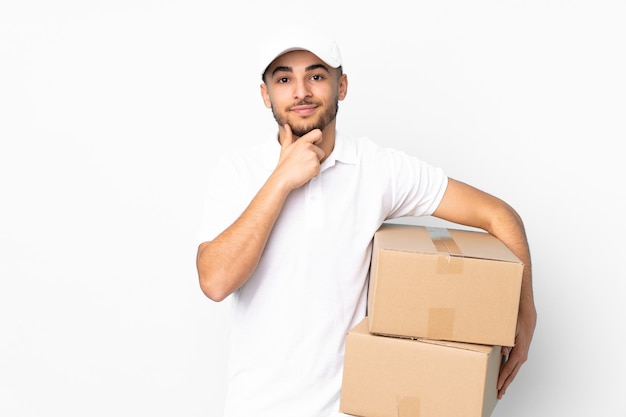 Delivery Arabian man isolated on blue wall laughing