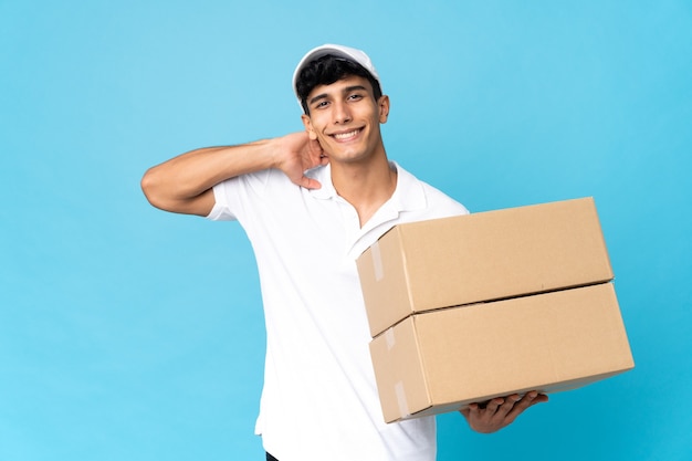 Delivery Argentinian man isolated on blue background laughing