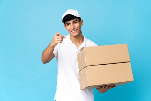 Delivery Argentinian man isolated pointing front with happy expression