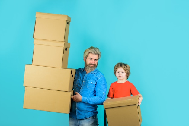 Delivery bearded man carry boxes happy son and father with cardboard box internet purchases and