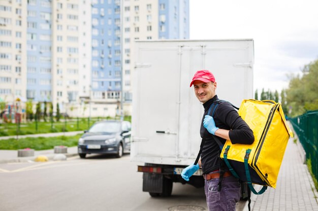 delivery boy of food delivery service walking down the street