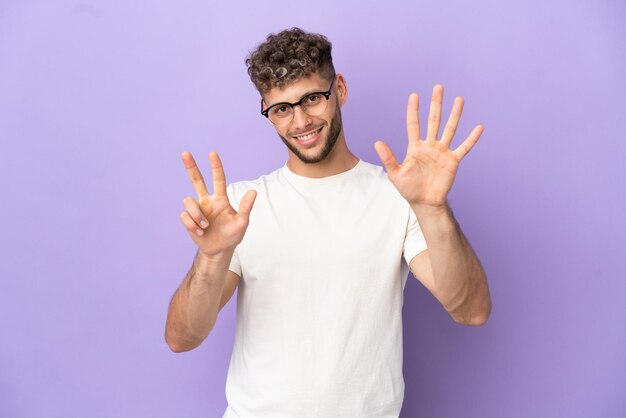 Delivery caucasian man isolated on purple background counting eight with fingers