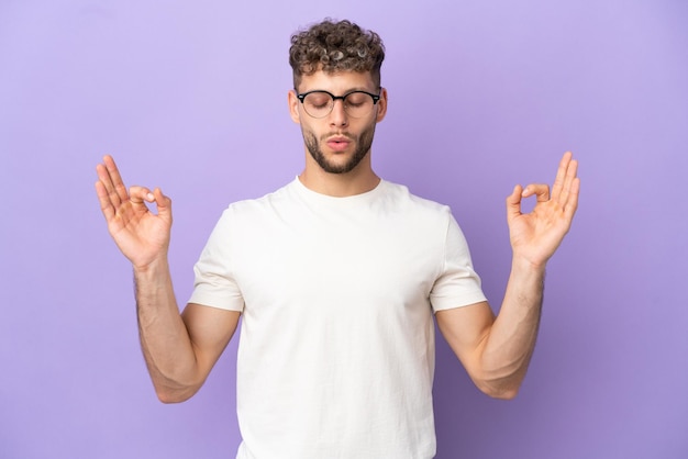 Delivery caucasian man isolated on purple background in zen pose