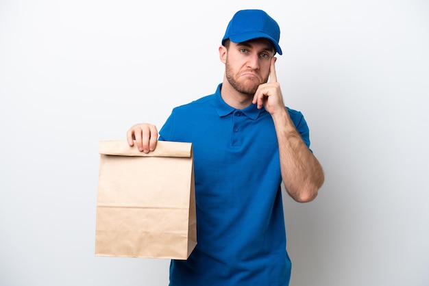 Delivery caucasian man isolated on white background thinking an idea