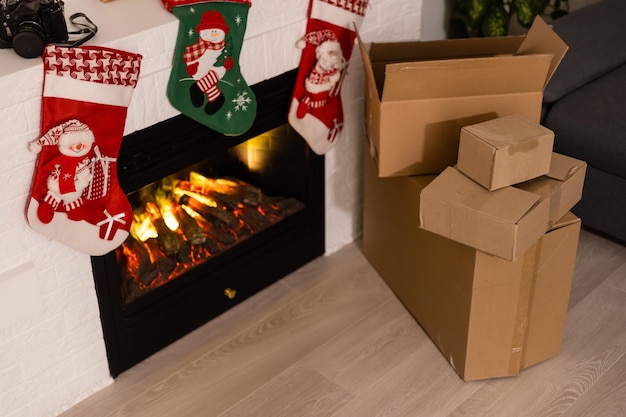 delivery christmas gifts. delivery boxes near fireplace before christmas