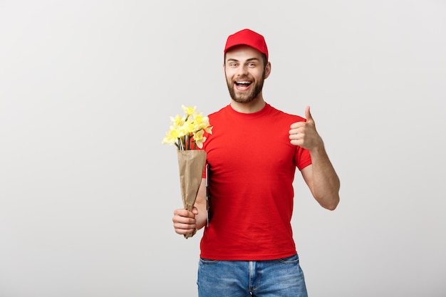 Delivery Concept: Portrait of happy flower delivery man holding beautiful bouquet flower