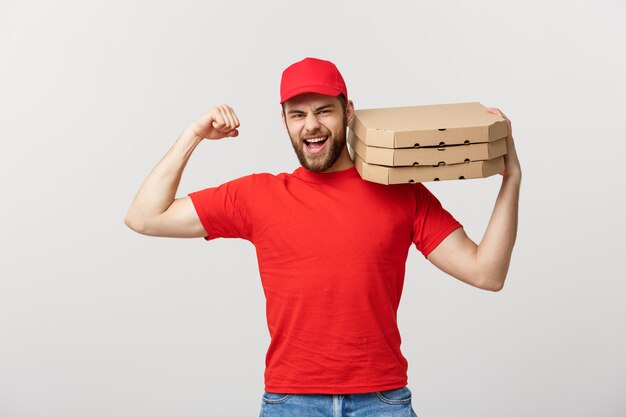 Delivery Concept - Portrait of Strong handsome delivery man flexing his muscle and holding pizza box