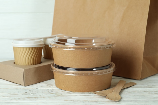 Delivery containers for takeaway food on white wooden table