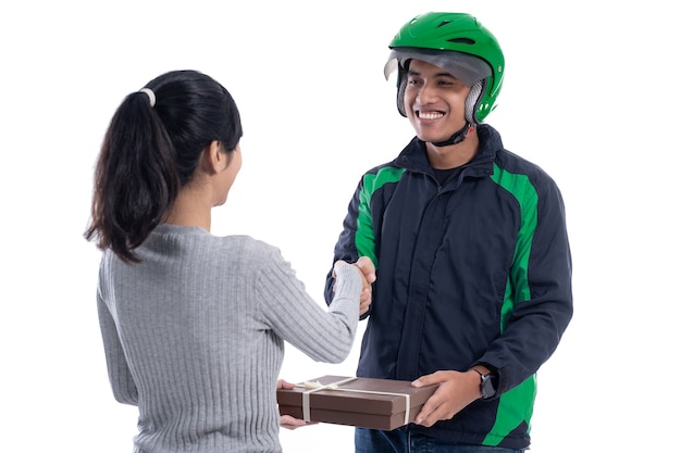 Delivery courier with helmet and uniform sending package to female customer