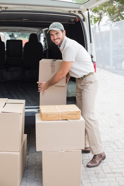 Delivery driver loading his van with boxes 