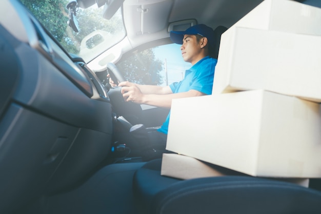 Delivery driver and packages on seat.