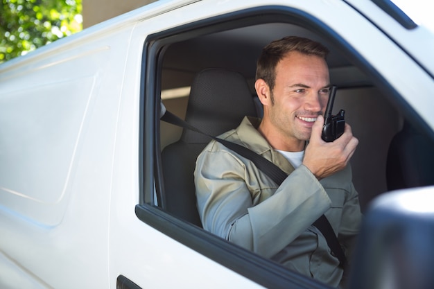 Delivery driver talking on walkie-talkie