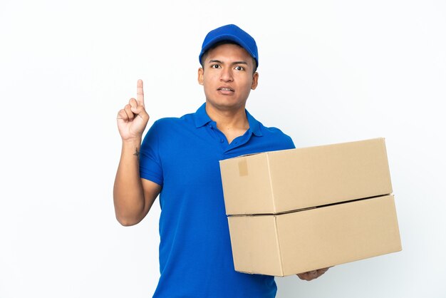 Delivery Ecuadorian man isolated on white background thinking an idea pointing the finger up