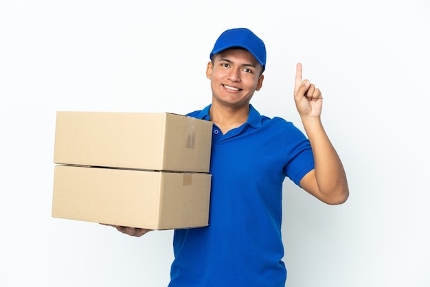 Delivery Ecuadorian man isolated on white wall pointing up a great idea