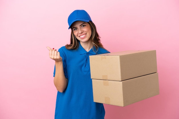 Delivery Italian woman isolated on pink background making money gesture