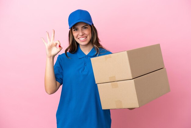 Delivery Italian woman isolated on pink background showing ok sign with fingers