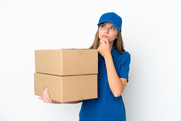 Delivery Lithuanian woman isolated on white background having doubts