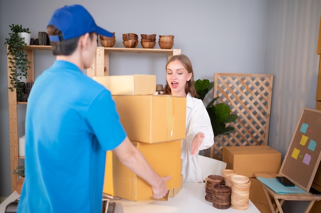 The delivery man brings the goods that the customer purchased and delivers them to the customer