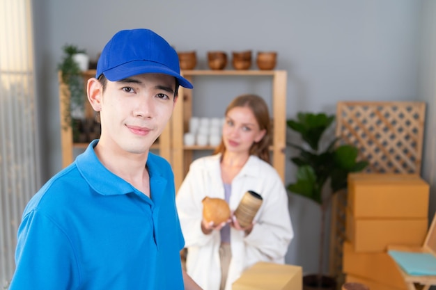 The delivery man brings the goods that the customer purchased and delivers them to the customer