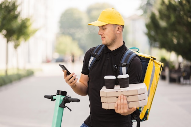 Delivery man in cap talking on smartphone