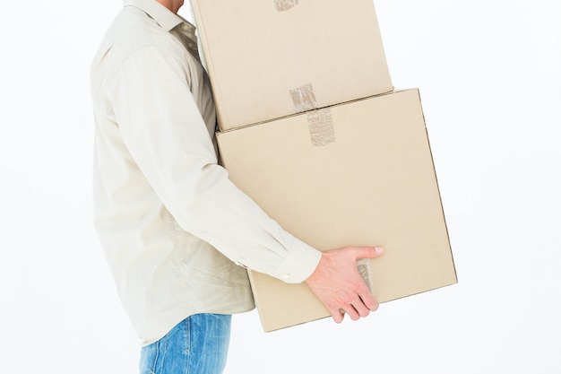 Delivery man carrying cardboard boxes