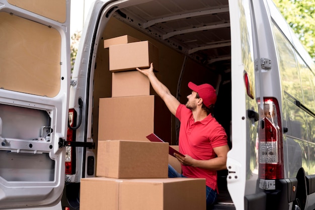 Delivery man checking packages