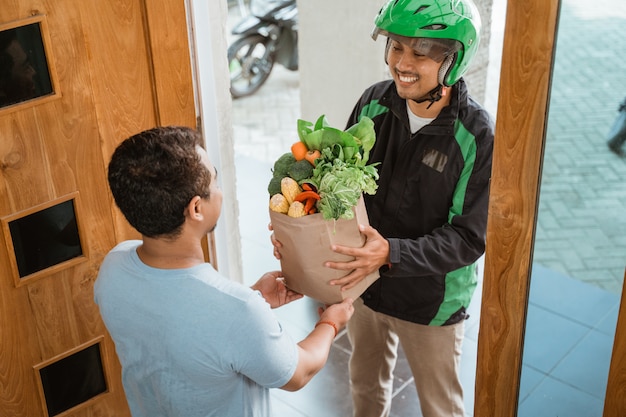 Delivery man delivering grocery