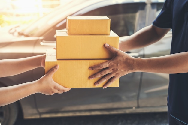 Delivery man delivering holding parcel box to customer