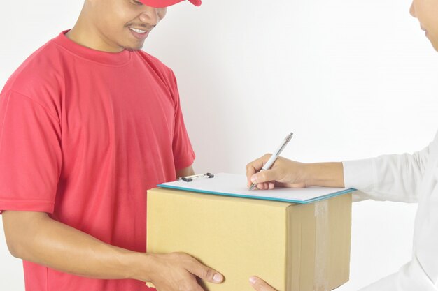 Delivery man delivering parcel to customer. Woman receiving a package from courier.