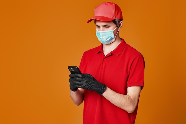 Delivery man employee in red cap face mask empty cardboard box