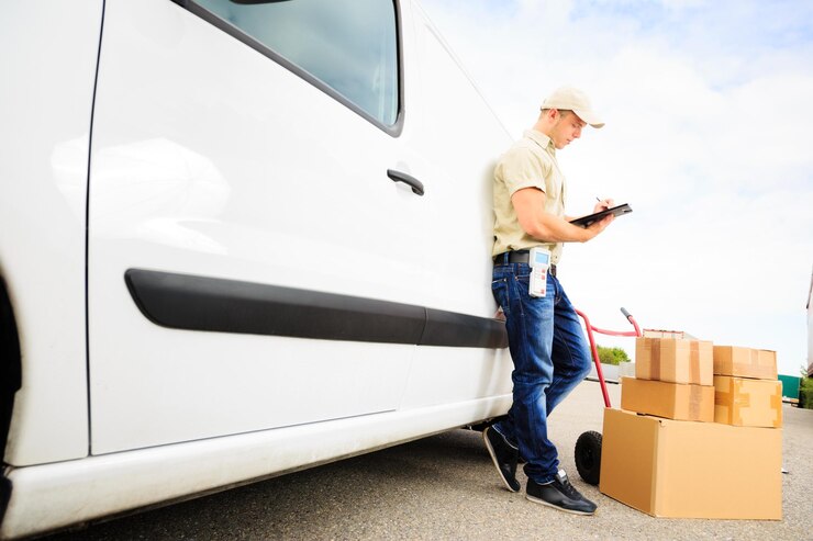 Photo delivery man holding clipboard by van