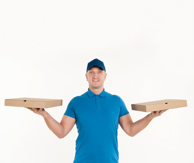 Delivery man holding pizza boxes in each hand