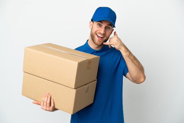 Delivery man over isolated white background making phone gesture. Call me back sign