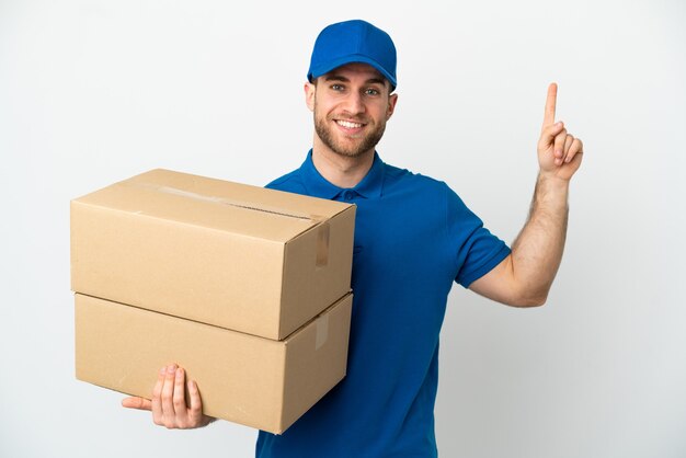 Delivery man over isolated white background pointing up a great idea