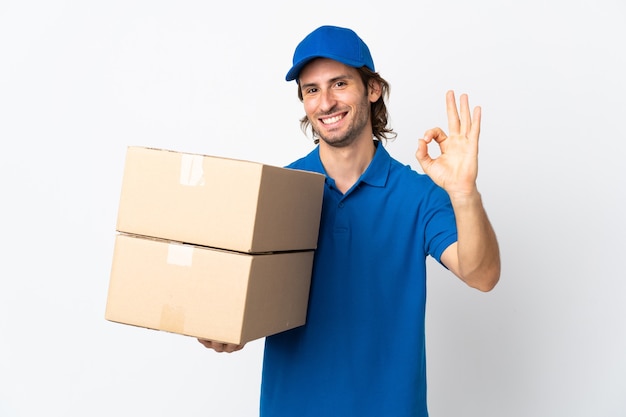 Delivery man isolated on white background showing ok sign with fingers