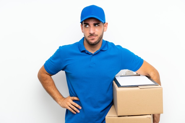 Delivery man over isolated white  thinking an idea