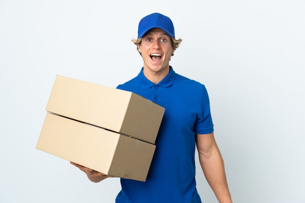 Delivery man over isolated white wall with surprise facial expression