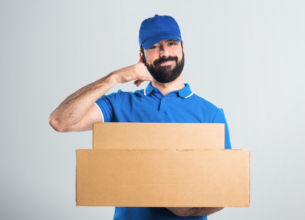 Delivery man making phone gesture